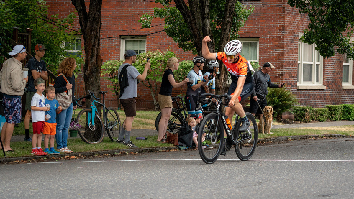 Dialed Cycling Team rider racing the Vancouver Courthouse Crit as spectators watch