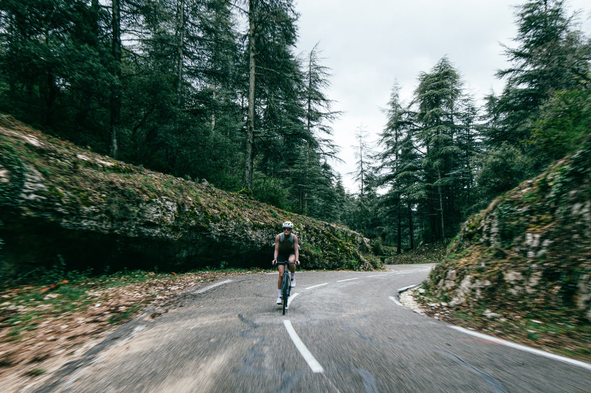 Road rider on an ENVE Fray descending a forested mountain road