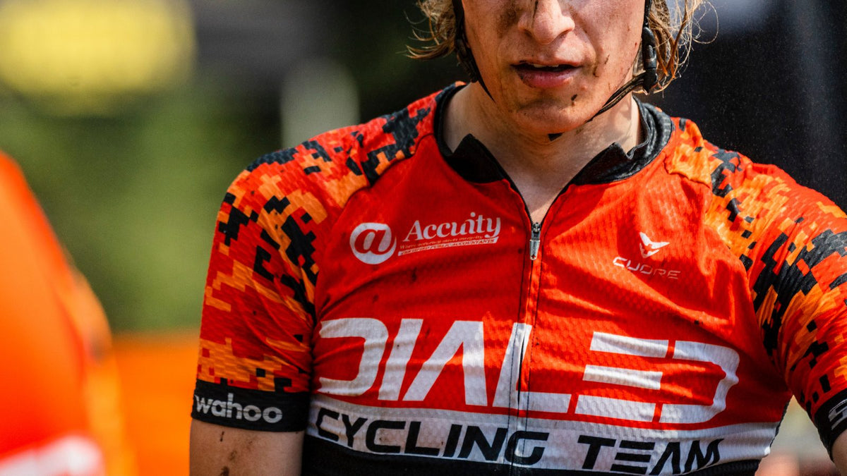 Close crop of a rider in the Dialed Cycling Team jersey after a race