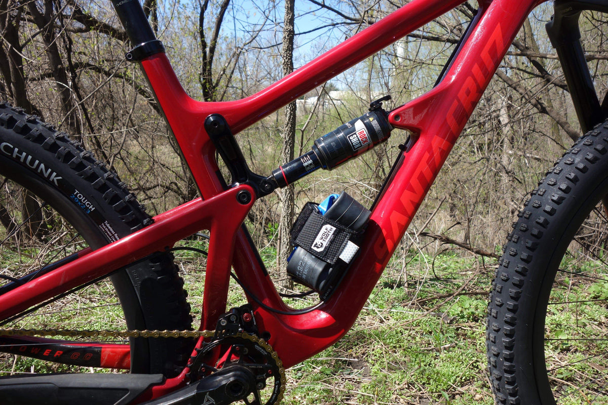 Spare tube strapped to a Wolf Tooth B-RAD strap mount below the rear shock on a full-suspension mountain bike