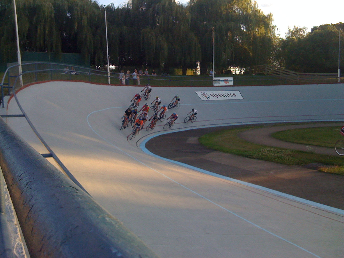 A pack of track racers in the banked turn at Alpenrose Velodrome in Portland