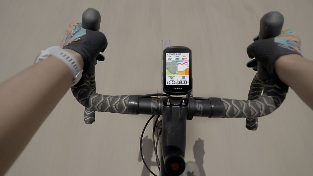 Rider's view of a Garmin Edge bike computer mounted on a road bike handlebar
