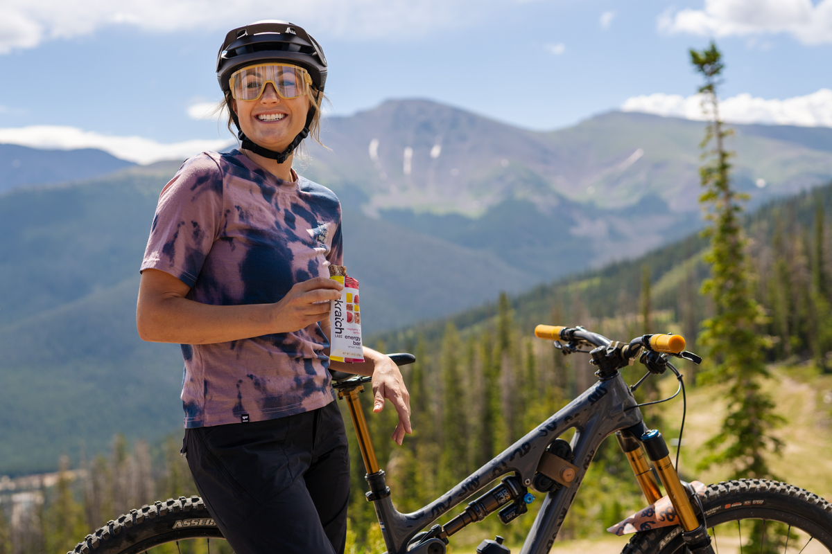 Mountain biker holding a Skratch Labs drink in the mountains
