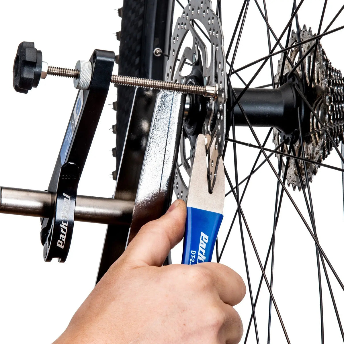 Park Tool DT-2.2 truing a disc brake rotor on a mountain bike wheel
