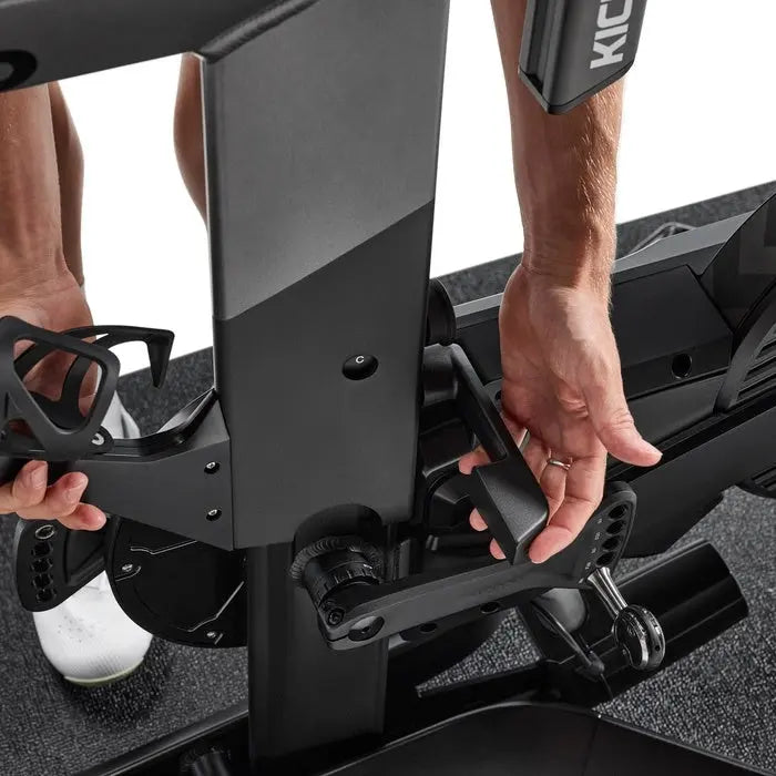 Rider adjusting the Wahoo KICKR BIKE PRO fit